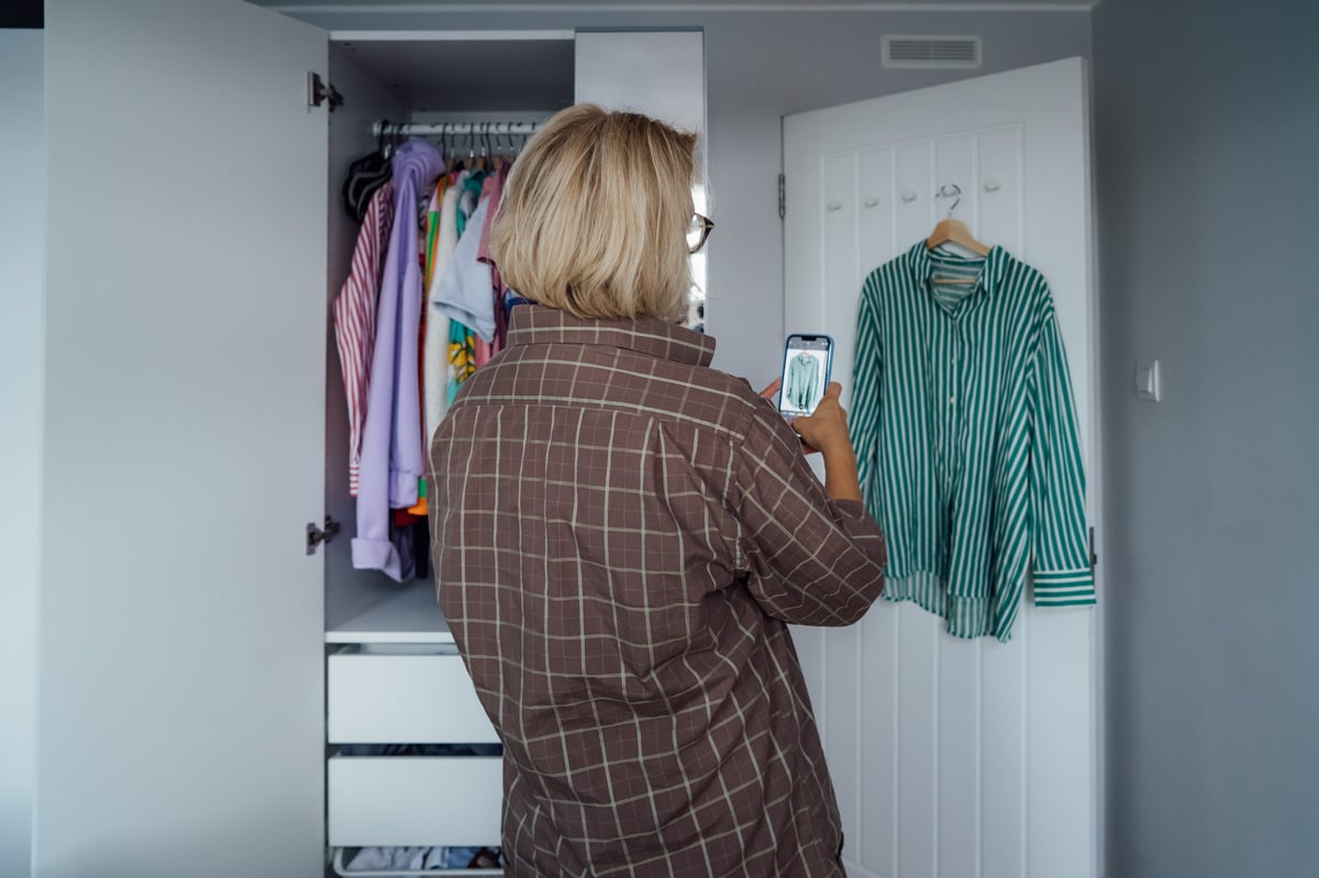 Woman photographing clothes to resell them