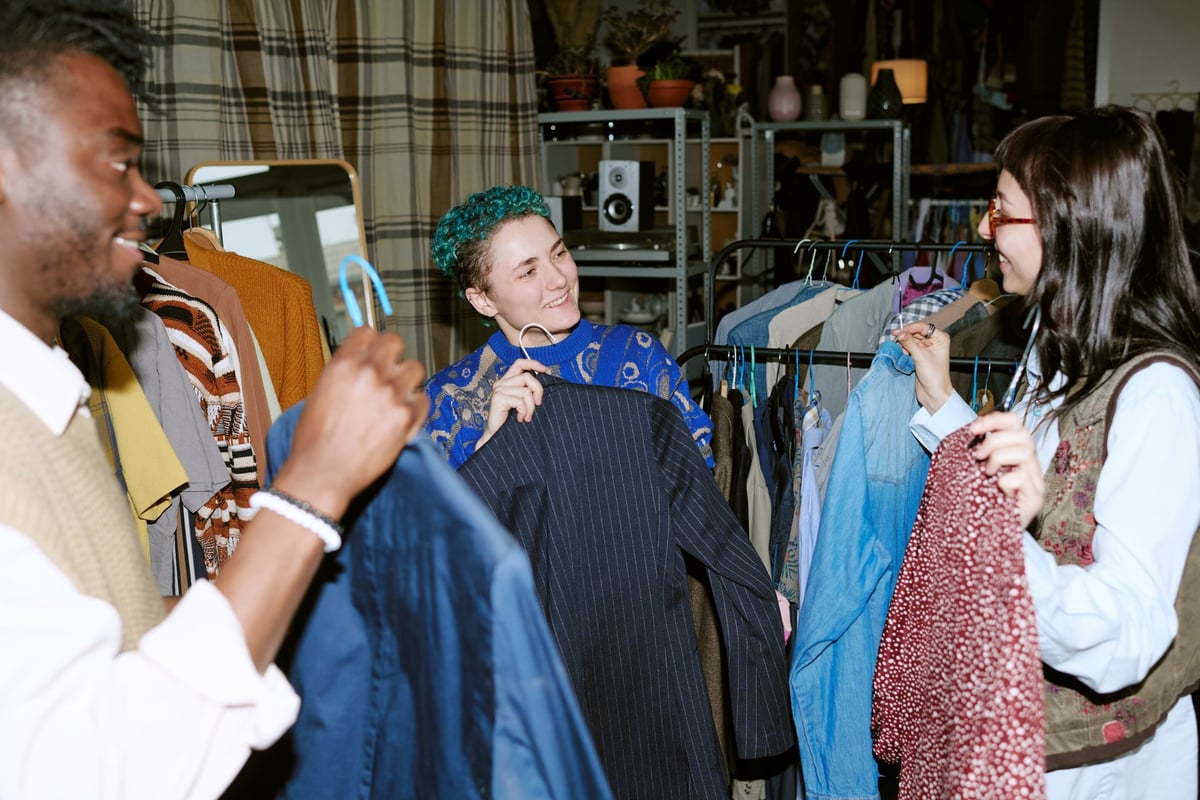 Customers browsing curated secondhand clothing racks at Empire Buddies